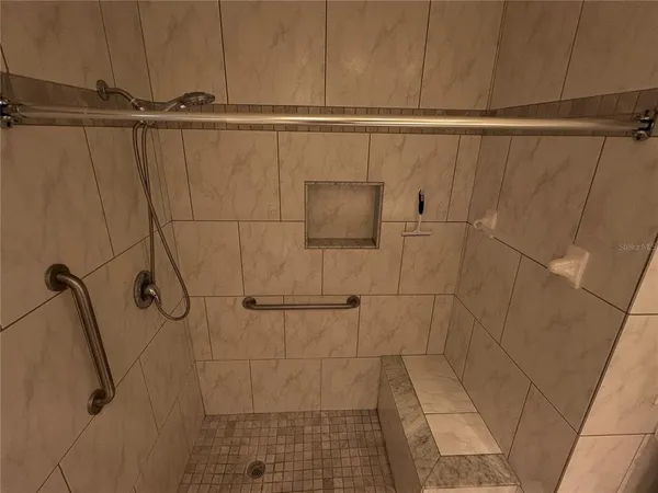 a bathroom with a granite countertop sink a toilet and mirror