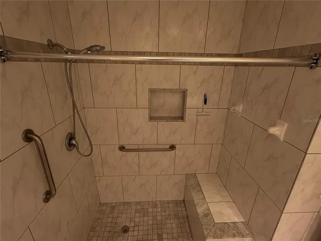 a bathroom with a granite countertop sink a toilet and mirror