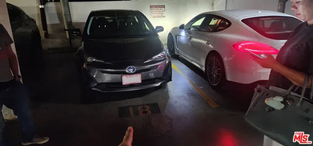 a car parked in front of a house and a car parked on the road