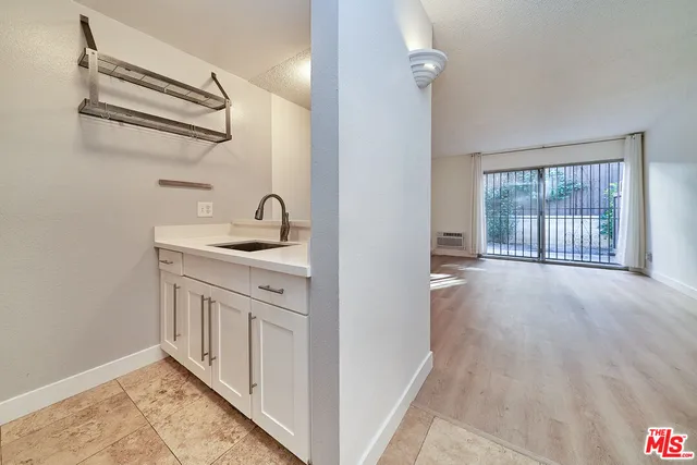 a kitchen with stainless steel appliances granite countertop white cabinets and window