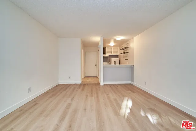a view of a kitchen with wooden floor