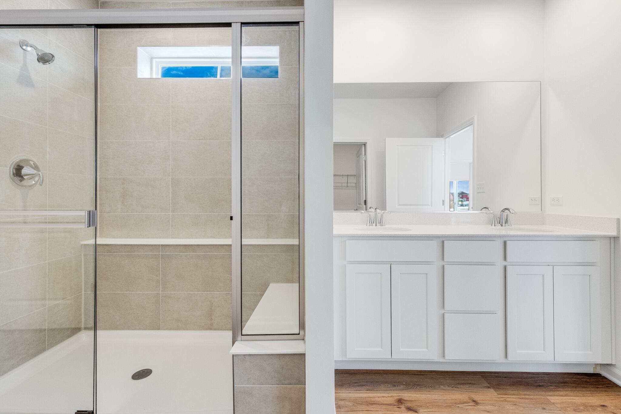 5948 East 112th Avenue Winfield, IN 46307 - Photo 18 of 36 a bathroom with a shower sink and mirror