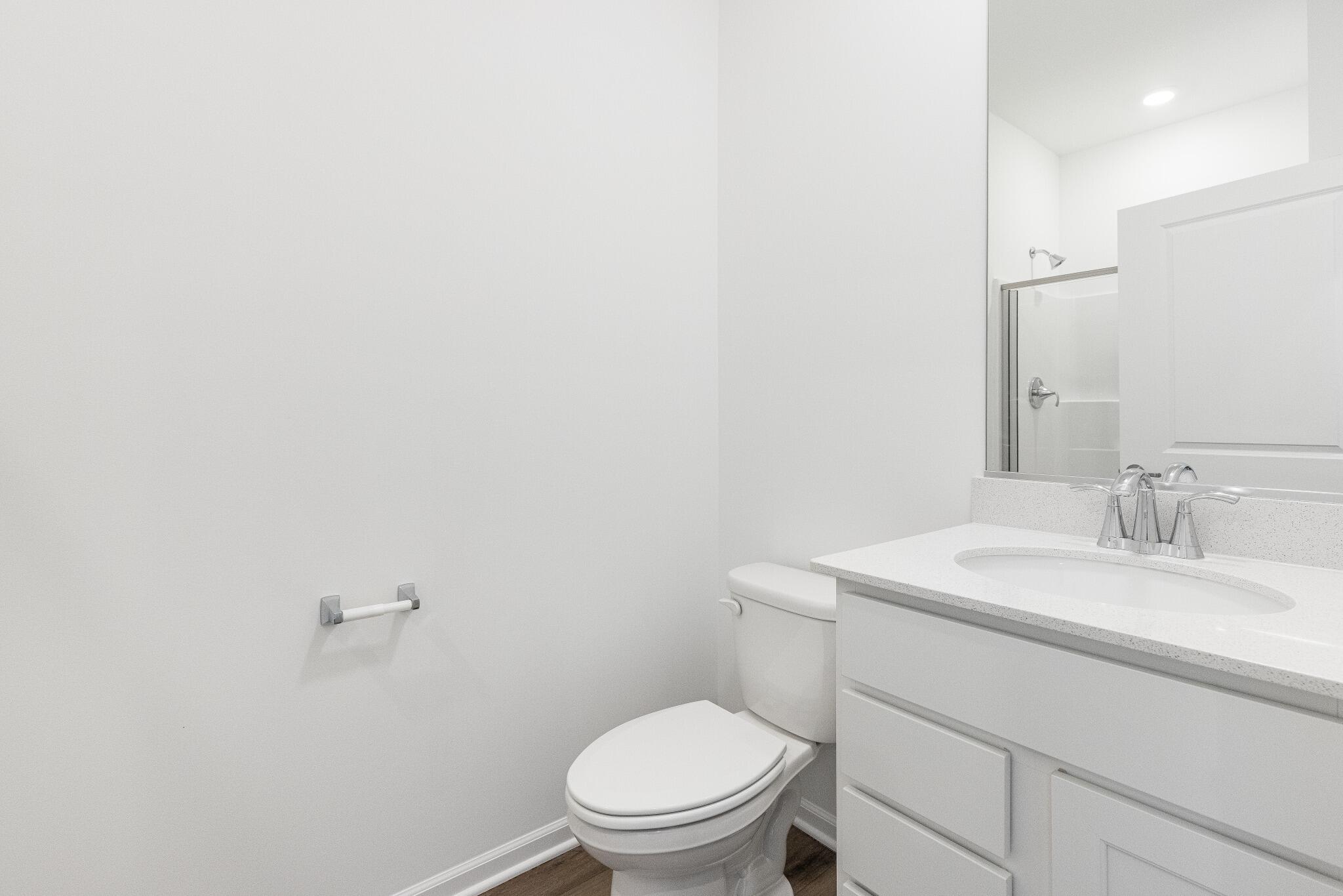 5948 East 112th Avenue Winfield, IN 46307 - Photo 23 of 36 a bathroom with a toilet a sink and mirror