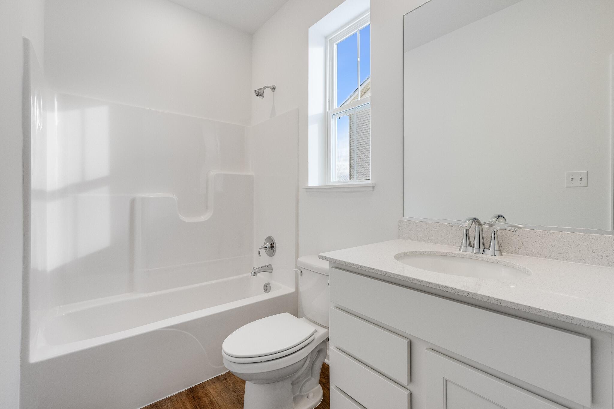 5948 East 112th Avenue Winfield, IN 46307 - Photo 7 of 36 a bathroom with a sink toilet vanity and bathtub