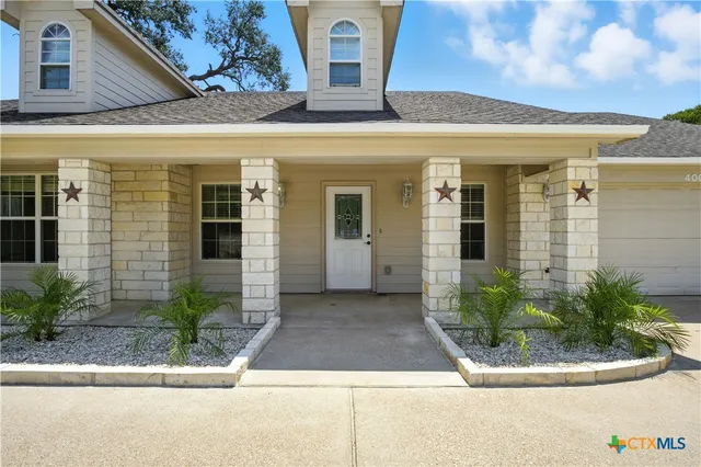 an empty room with fan and fireplace