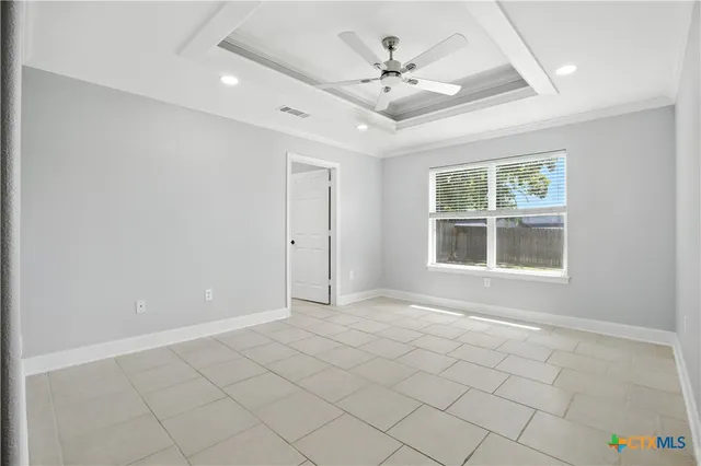a view of an empty room with window and cabinet