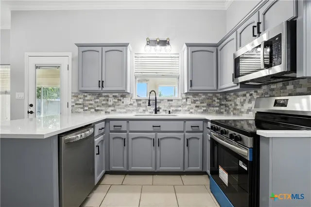 a kitchen with stainless steel appliances granite countertop a sink and stove