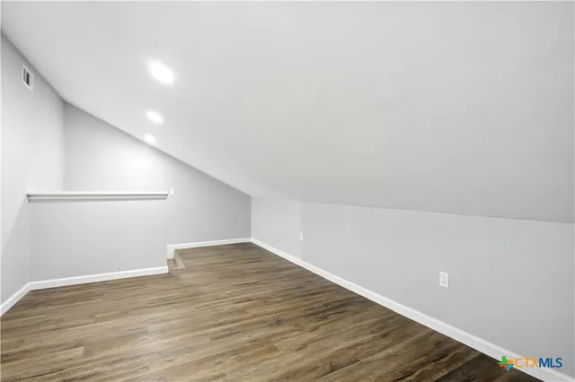 a front view of a house with a garden and lake view