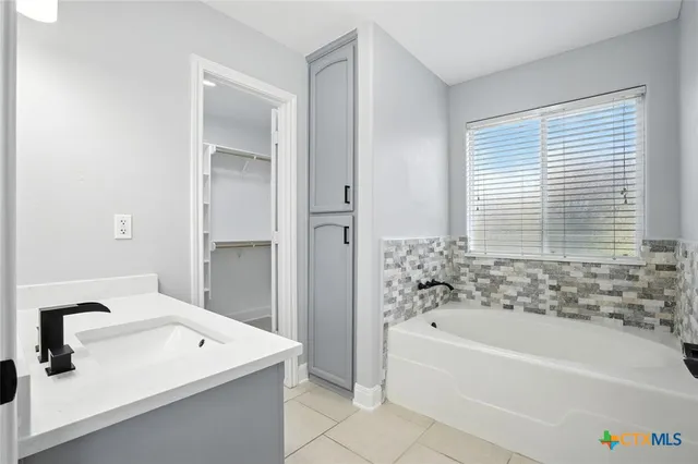 a bathroom with a bathtub and a shower