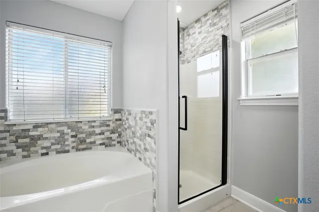 a bedroom with a bed and a chandelier fan