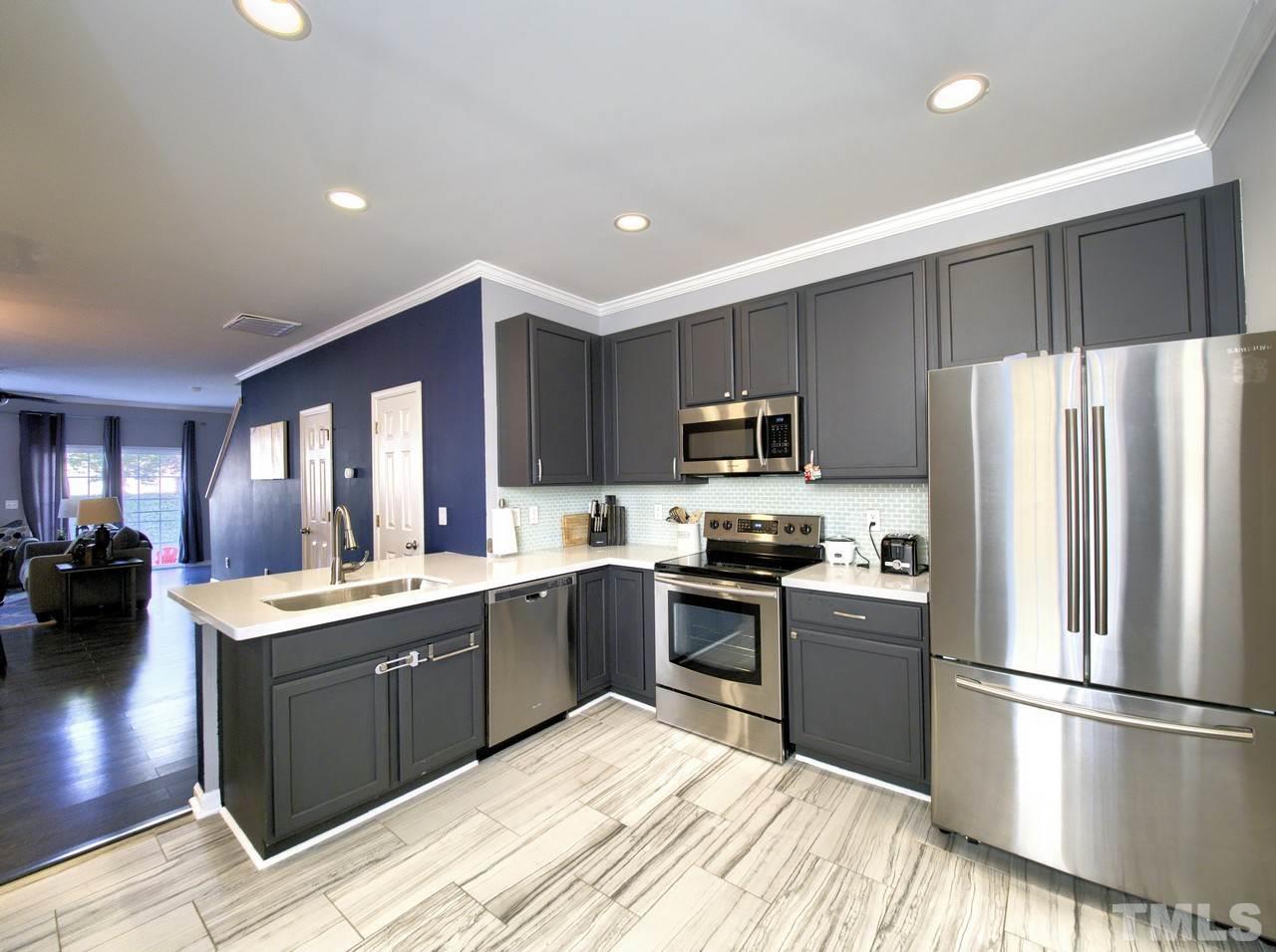 2609 Forest Shadows Lane Raleigh, NC 27614 - Photo 3 of 19 Recently updated with porcelain tile flooring, quartz countertops with under mount sink, all stainless steel appliances, glass backsplash and painted cabinets.