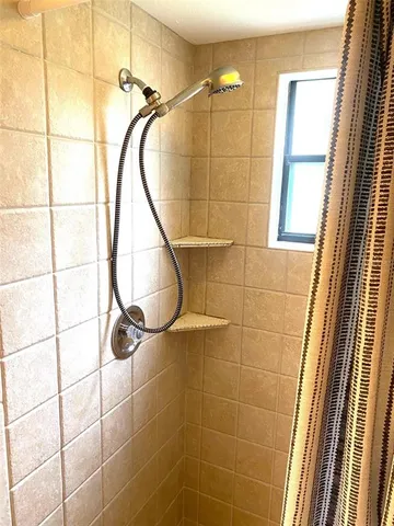 a bathroom with a shower and a glass door shower
