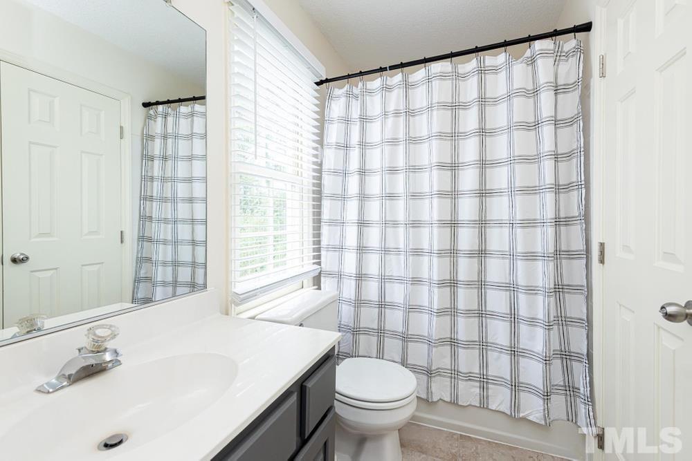 2316 Declaration Drive Raleigh, NC 27615 - Photo 22 of 30 a bathroom with a sink toilet and shower