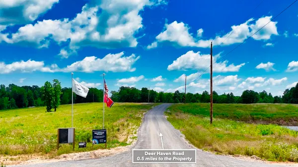 a view of a sign in front of flowers
