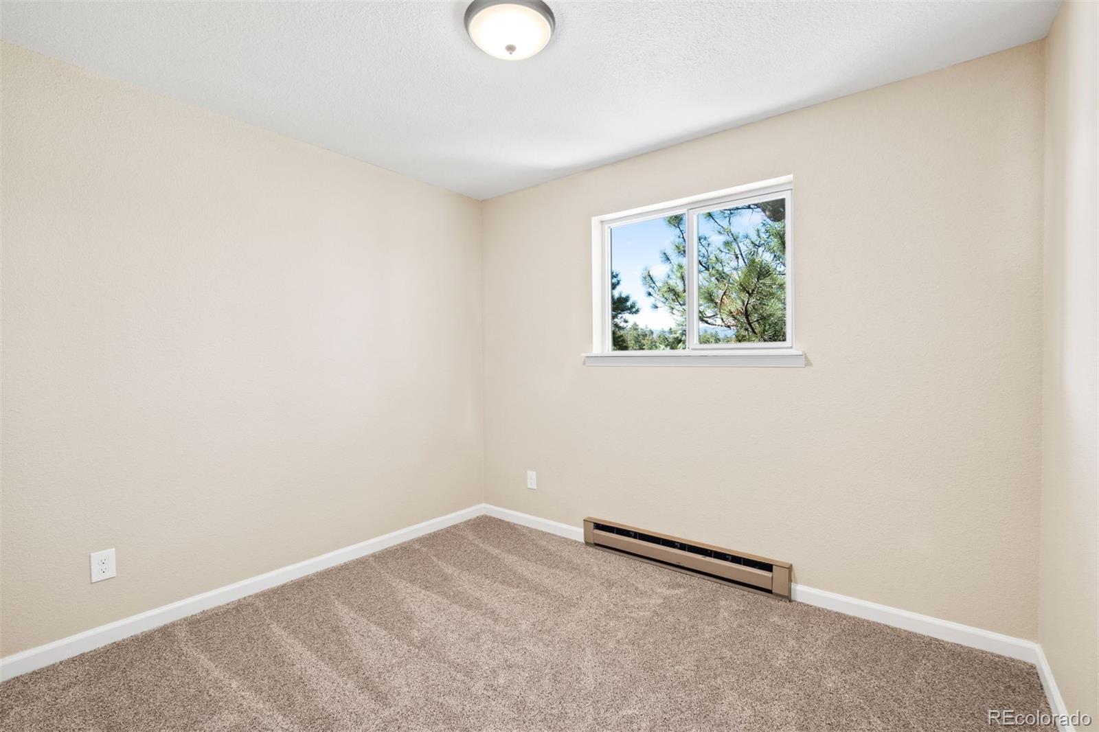 122 South Random Road Bailey, CO 80421 - Photo 16 of 38 an empty room with a workbench