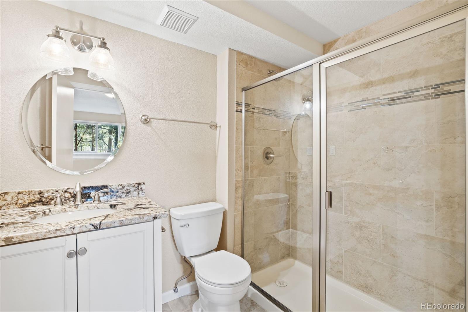 122 South Random Road Bailey, CO 80421 - Photo 20 of 38 a bathroom with a granite countertop sink toilet and shower