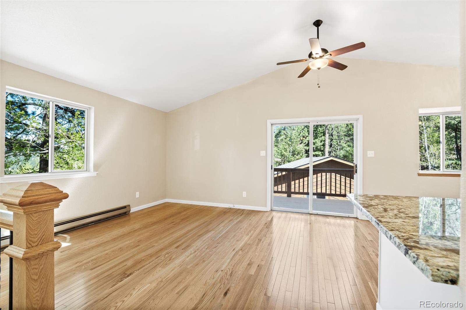 122 South Random Road Bailey, CO 80421 - Photo 5 of 38 a view of an empty room with wooden floor and a window