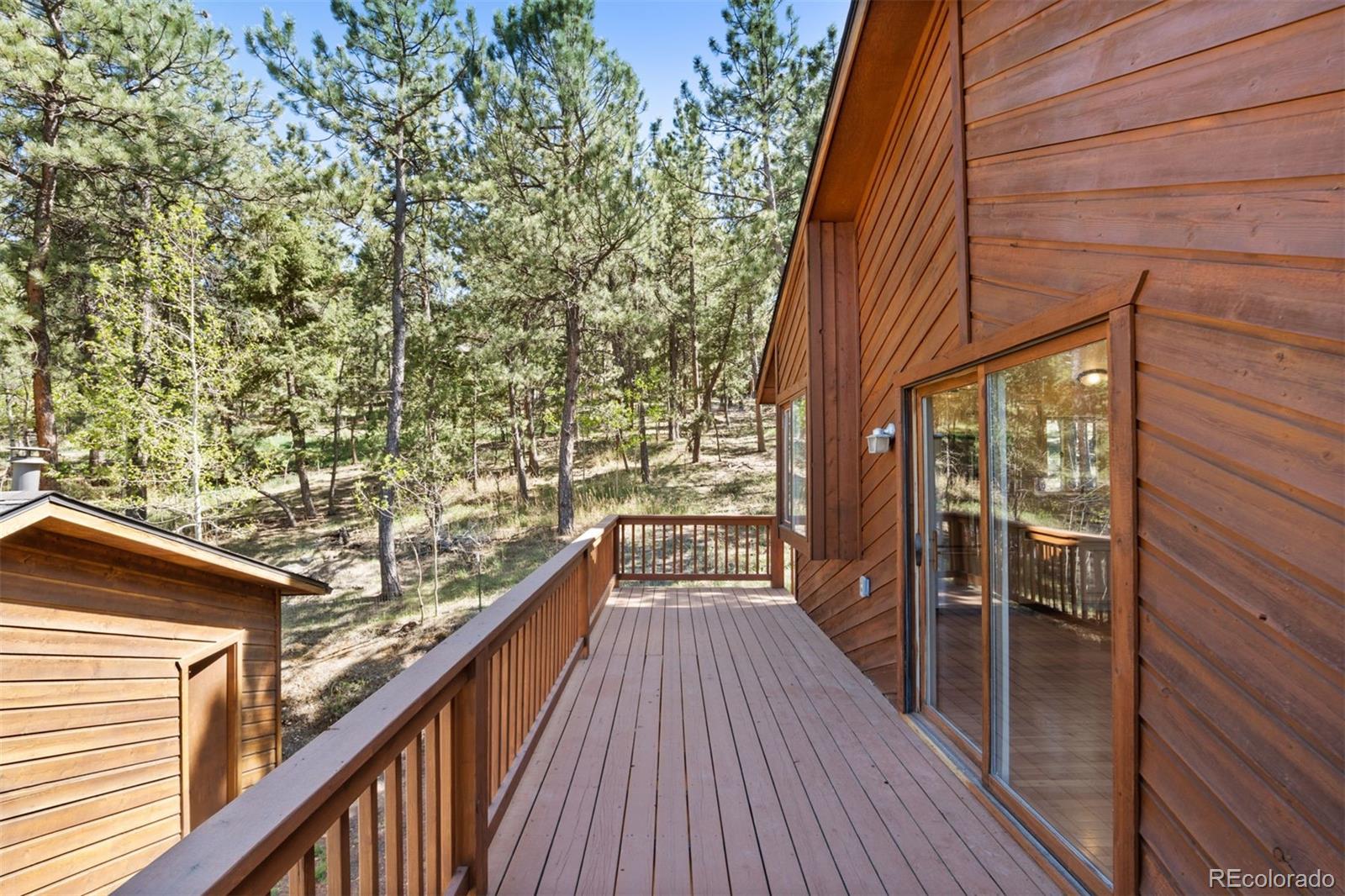 122 South Random Road Bailey, CO 80421 - Photo 6 of 38 a view of balcony with wooden floor and fence