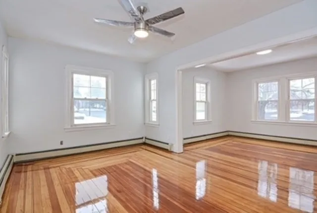 wooden floor in an empty room with a window