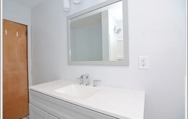 a bathroom with a sink and a mirror