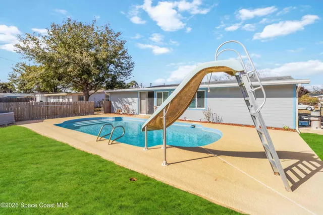 a view of a swimming pool with a garden