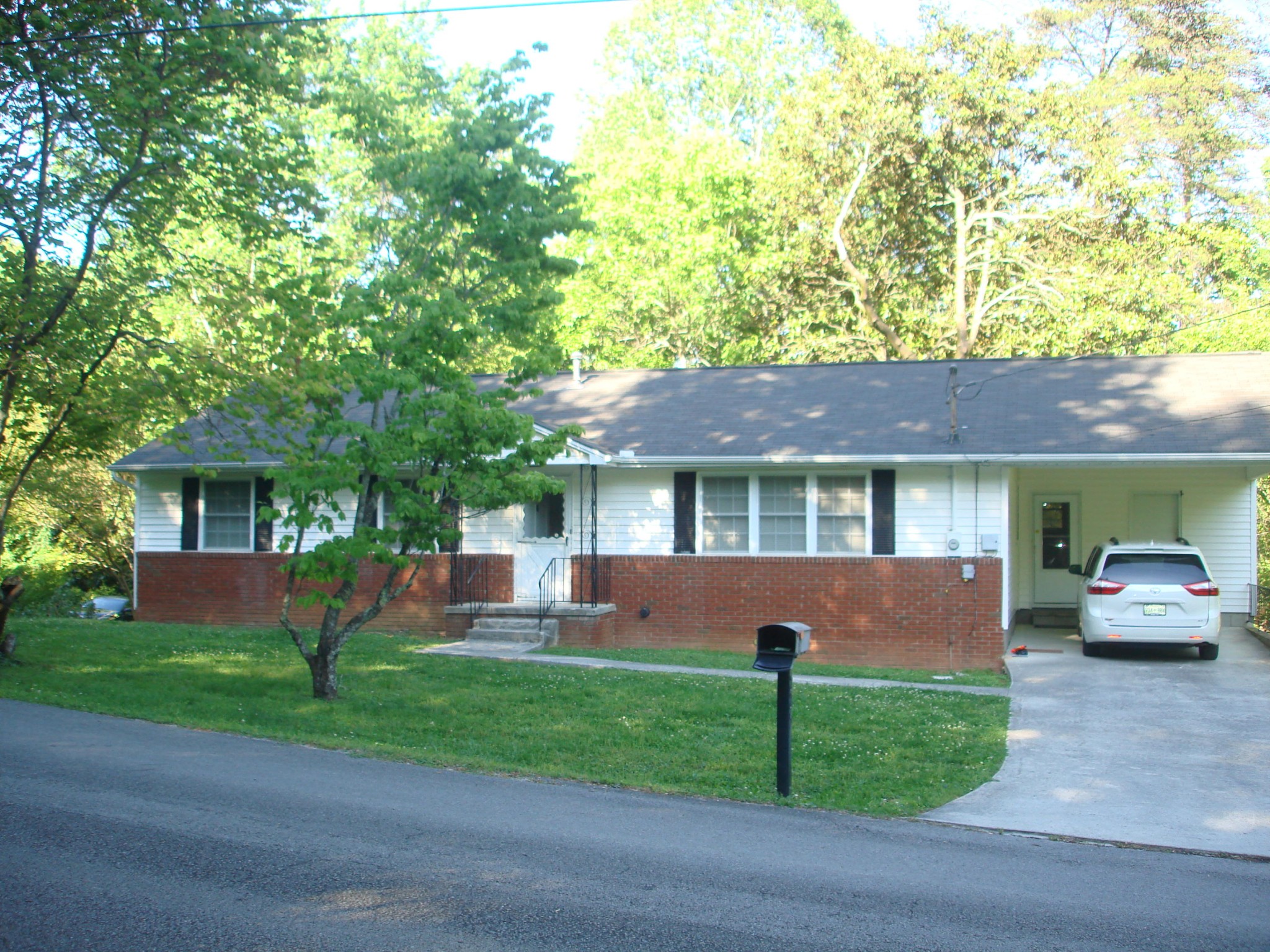 225 Sherwood Road Powell, TN 37849 - Photo 1 of 17 a front view of a house with a garden