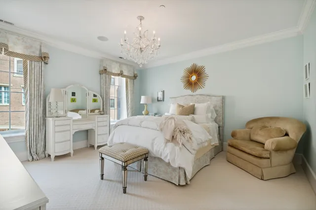 a living room with furniture a flat screen tv and a refrigerator