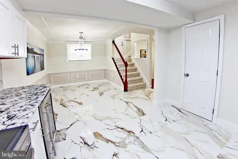 a kitchen with stainless steel appliances granite countertop a stove oven and white cabinets