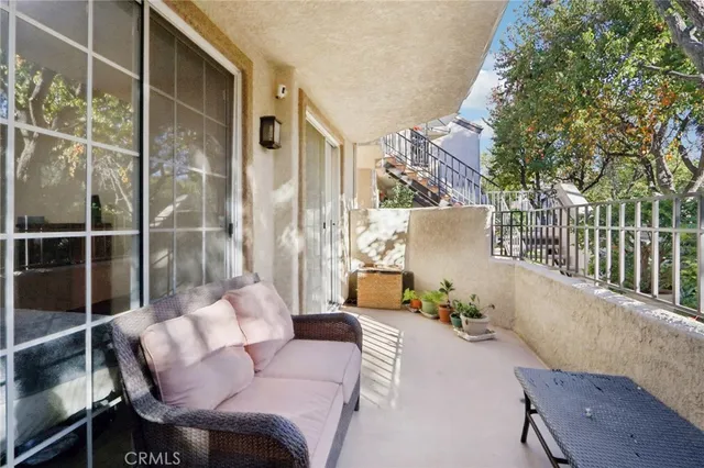 a balcony with table and chairs
