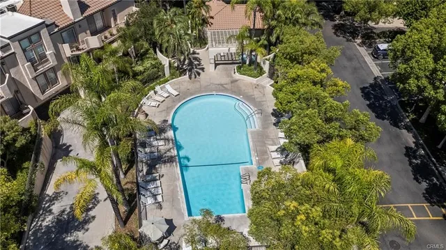 an aerial view of a house with garden space and swimming pool