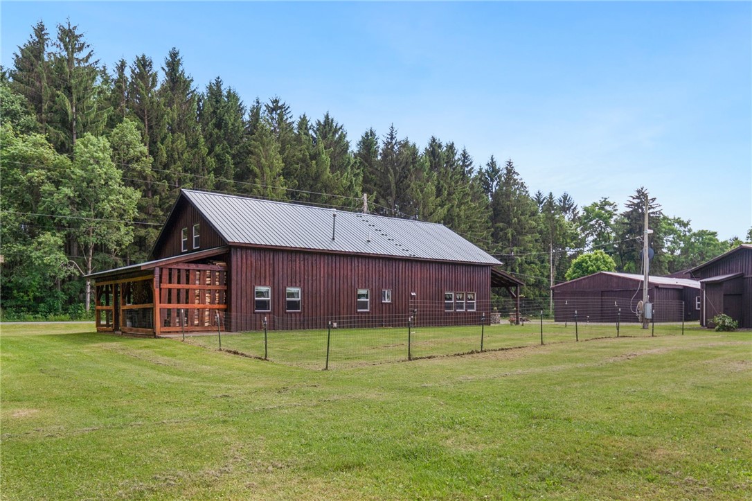 5903 Howell Road Locke, NY 13092 - Photo 26 of 31 Back patio offers covered wood storage for wood st