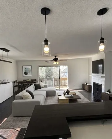 a living room with furniture a flat screen tv and a window