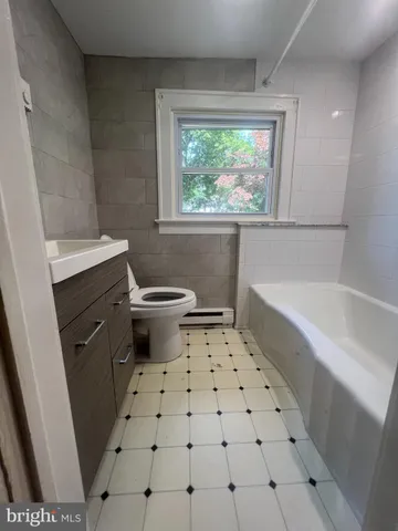 a bathroom with a sink a toilet and a bathtub