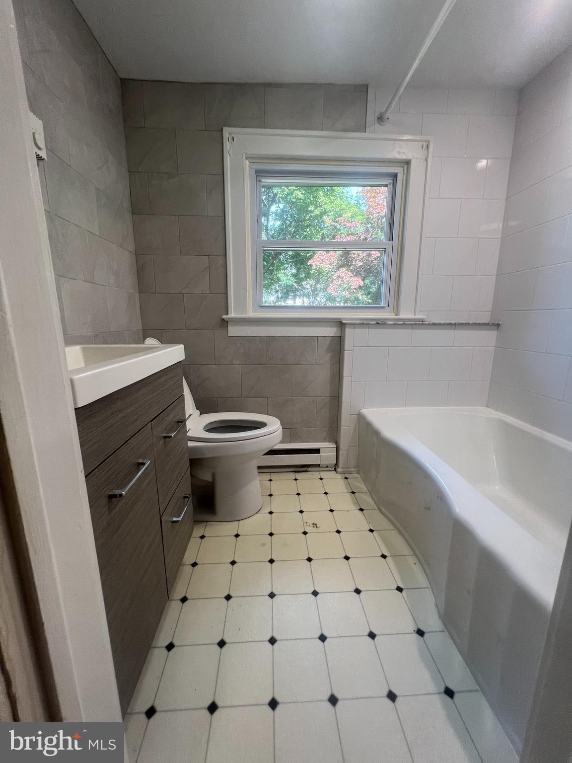 8 Ewington Avenue, Unit 1 Ewing, NJ 08638 - Photo 5 of 5 a bathroom with a sink a toilet and a bathtub