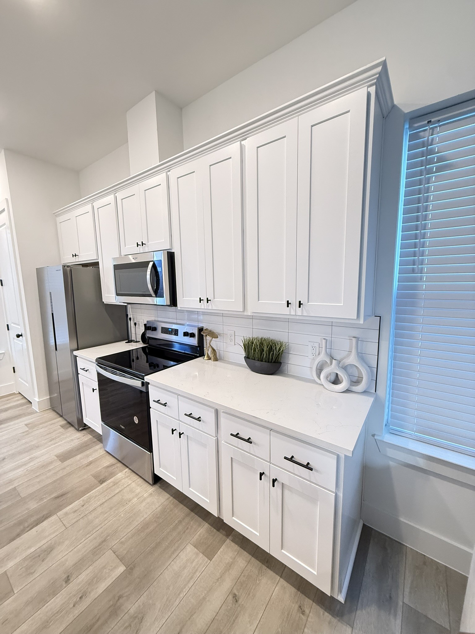 5527 Denmark Street, Unit B Houston, TX 77028 - Photo 21 of 40 a kitchen with white cabinets and white appliances