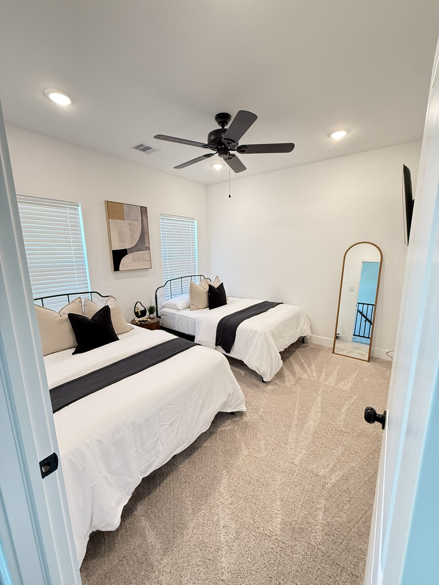 5527 Denmark Street, Unit B Houston, TX 77028 - Photo 4 of 40 a bedroom with two beds and a chandelier