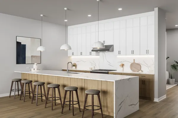 a kitchen with stainless steel appliances granite countertop a table chairs in it and wooden floors