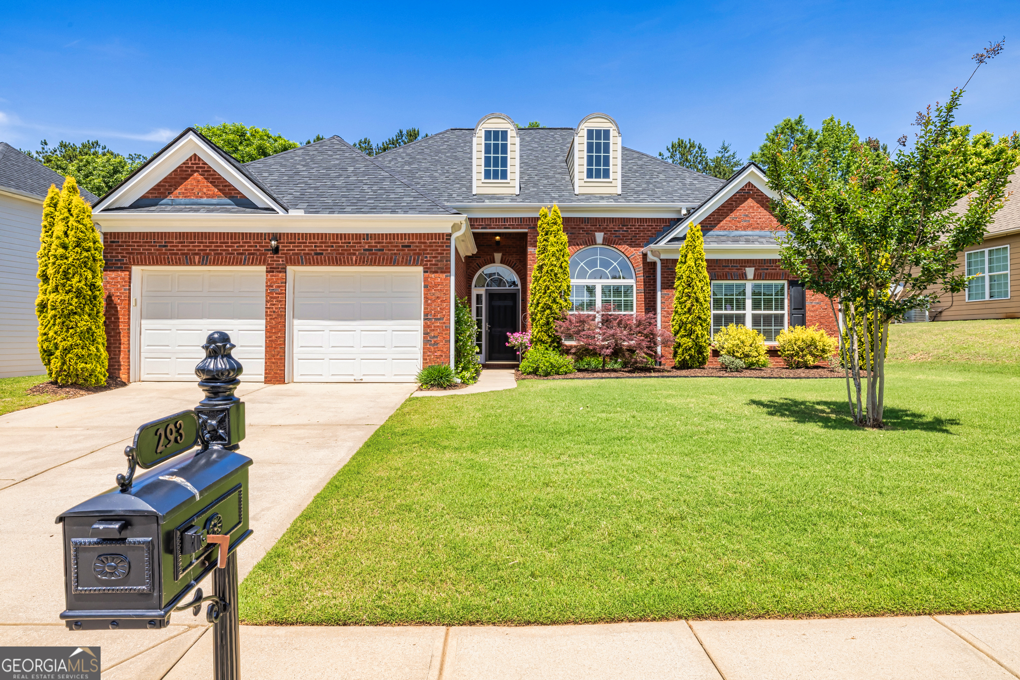 a front view of a house with garden