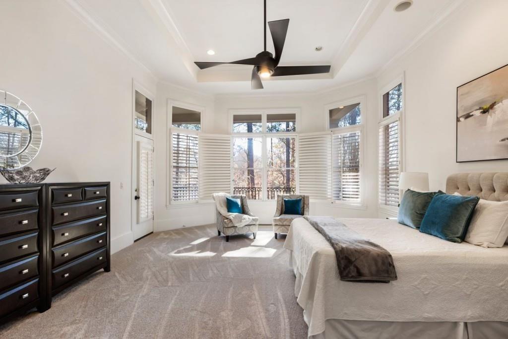 2250 Blackheath Trace Alpharetta, GA 30005 - Photo 16 of 51 a spacious bedroom with a bed a dresser and a window