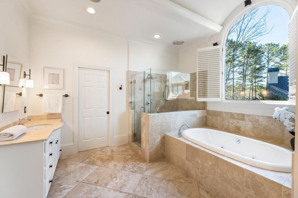 2250 Blackheath Trace Alpharetta, GA 30005 - Photo 17 of 51 a bathroom with a granite countertop tub sink and a shower
