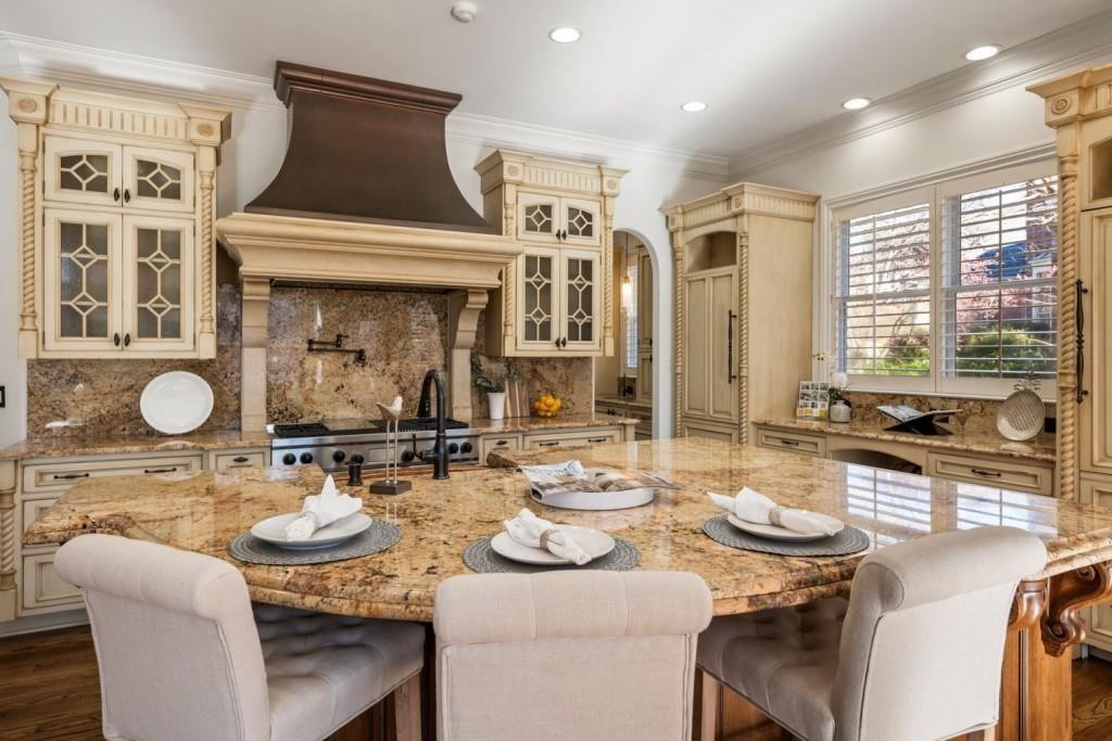 2250 Blackheath Trace Alpharetta, GA 30005 - Photo 20 of 51 a kitchen with a table chairs stove and kitchen island
