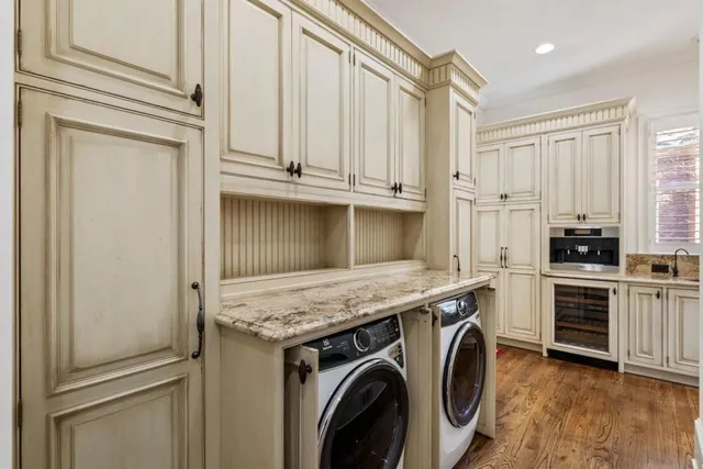 a kitchen with stainless steel appliances a stove and white cabinets