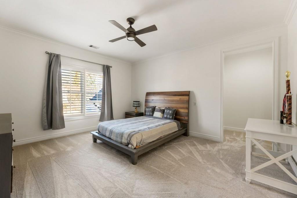 2250 Blackheath Trace Alpharetta, GA 30005 - Photo 30 of 51 a bedroom with a bed a chandelier and chair