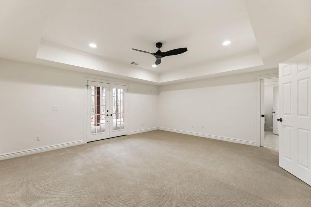 2250 Blackheath Trace Alpharetta, GA 30005 - Photo 41 of 51 an empty room with chandelier fan and windows