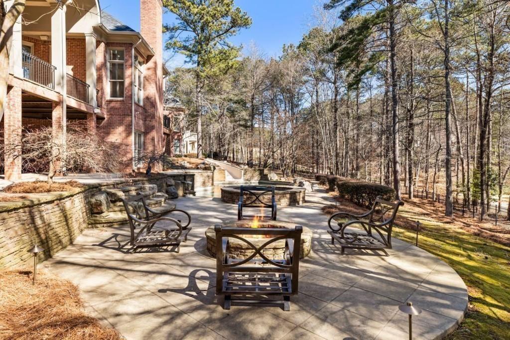 2250 Blackheath Trace Alpharetta, GA 30005 - Photo 45 of 51 a view of a patio with table and chairs with wooden floor and fence