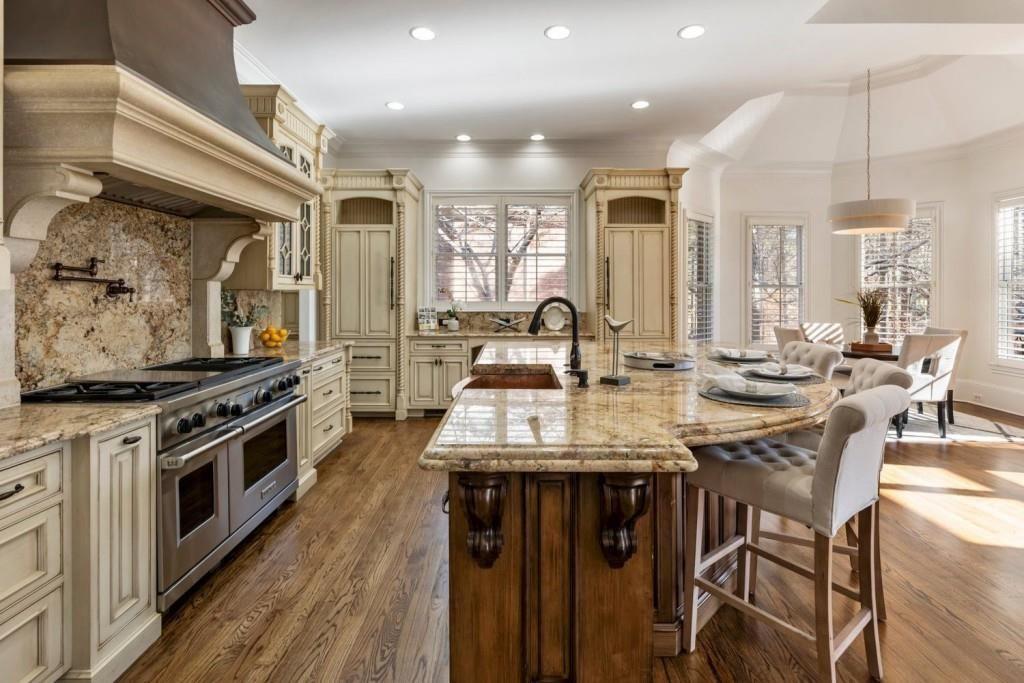 2250 Blackheath Trace Alpharetta, GA 30005 - Photo 10 of 51 a kitchen with stainless steel appliances a table chairs and a stove top oven