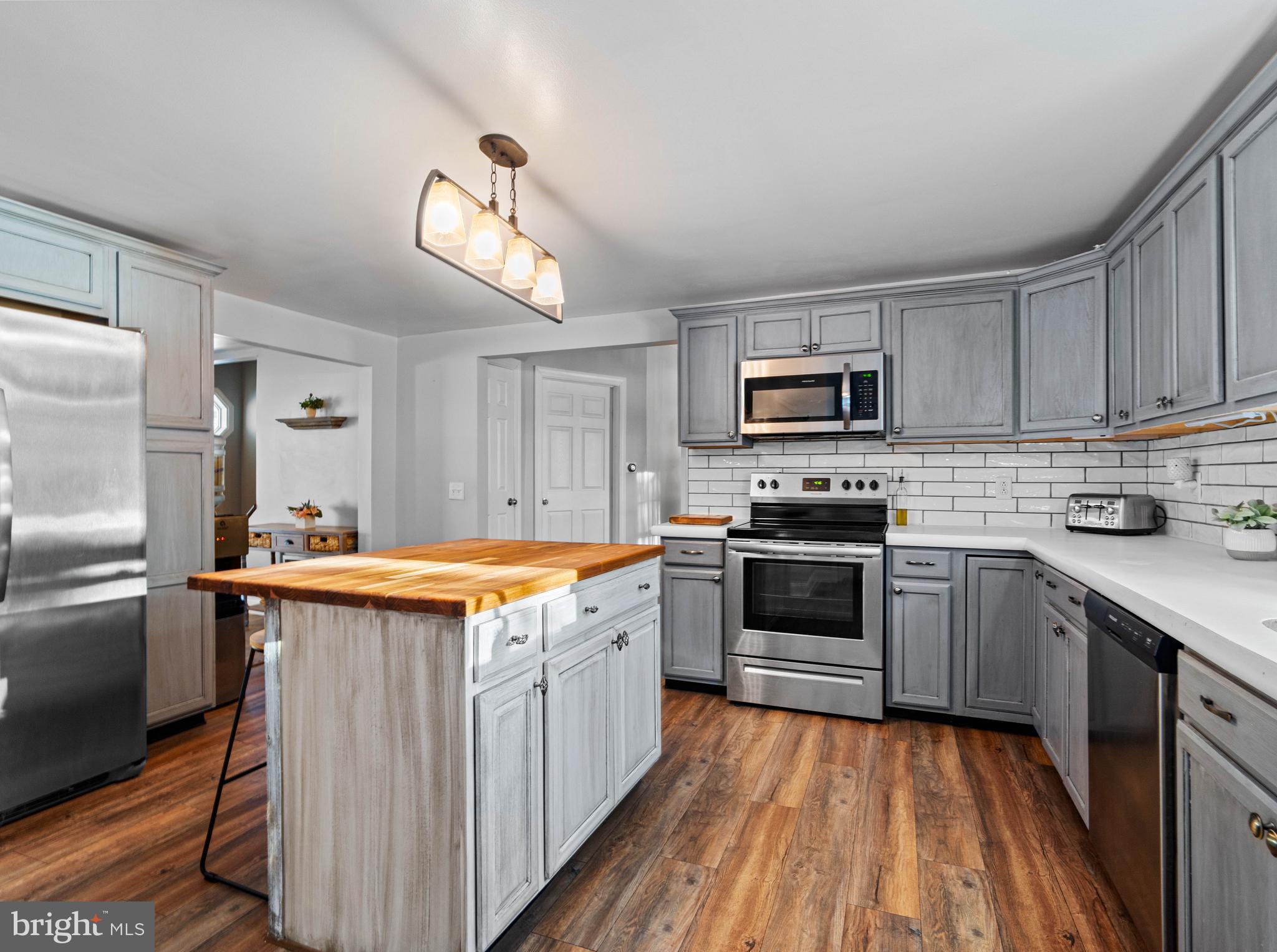 197 Ridge Street Smokerun, PA 16681 - Photo 8 of 47 a kitchen with stainless steel appliances granite countertop a stove top oven a sink dishwasher and a refrigerator