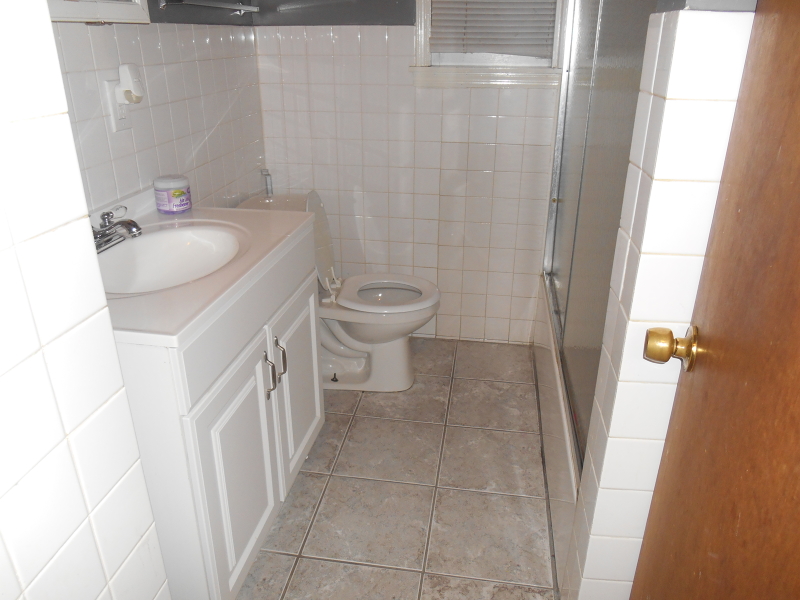 1214 Middlesex Street, Unit 1 Linden, NJ 07036 - Photo 3 of 5 a bathroom with a sink a toilet and a shower