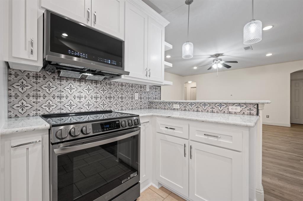 7103 Camp Creek Drive Arlington, TX 76002 - Photo 11 of 29 a kitchen with appliances a sink and cabinets