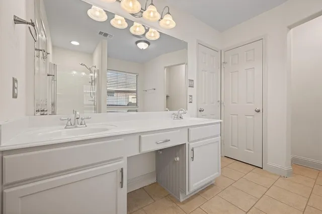 a bathroom with a double vanity sink and a mirror